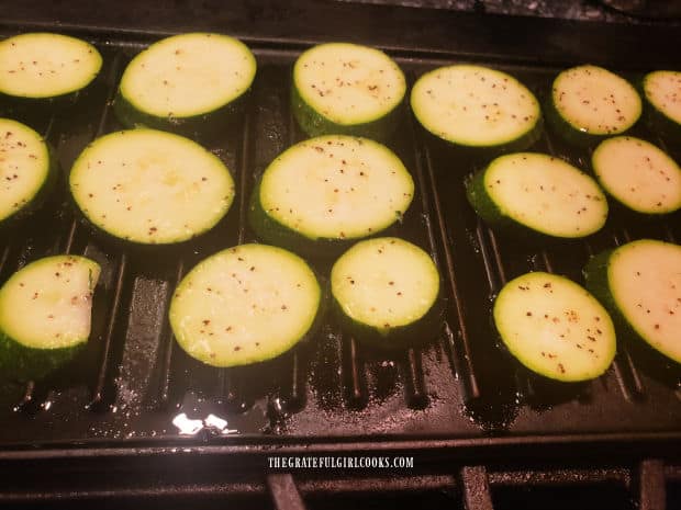 The zucchini slices are grilled on a hot indoor griddle.