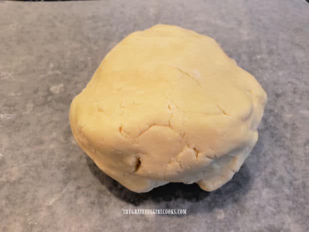 A ball of dough for the lemon meltaway cookies is formed.