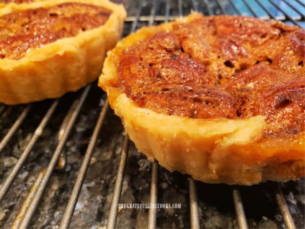 Transferred out of the tart pans, little pecan pies for two cool on a wire rack.