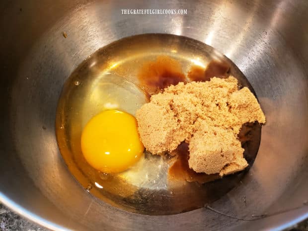 Egg, brown sugar, corn syrup and vanilla for pie filling are in a bowl.