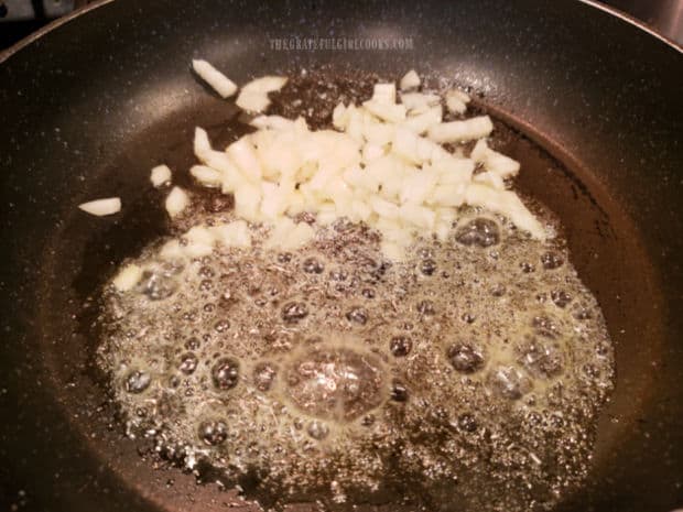Chopped onions are cooked in butter in a medium sized skillet.