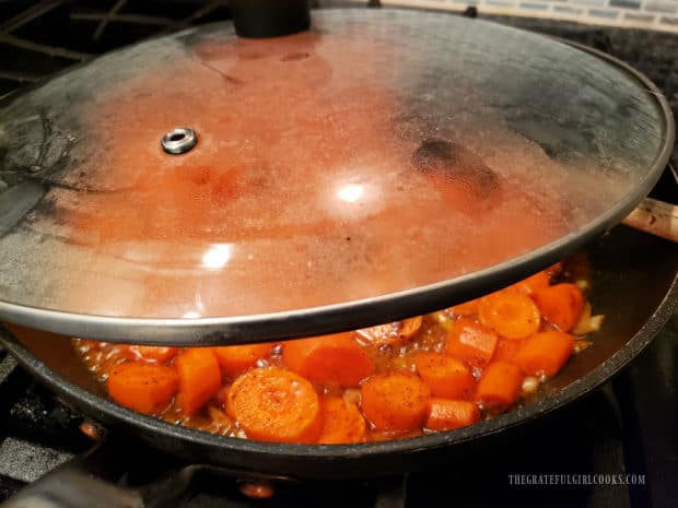 The skillet is left partially covered while the maple chili glazed carrots cook.
