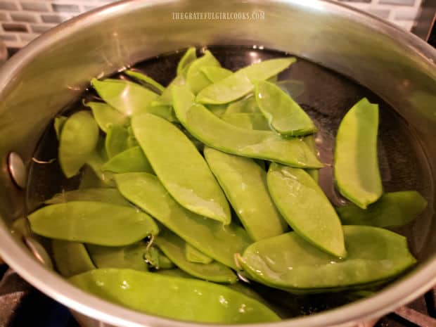 The sugar snap peas are boiled for 3-4 minutes until they become crisp-tender.