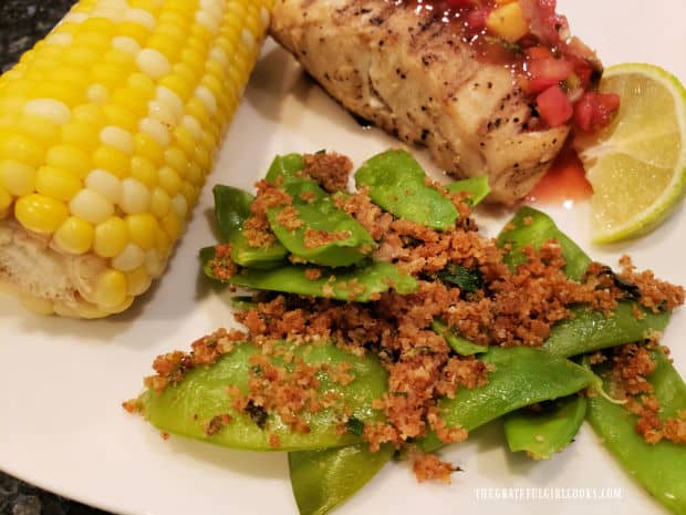 The Parmesan crumb sugar snap peas, on plate with corn and grilled halibut.