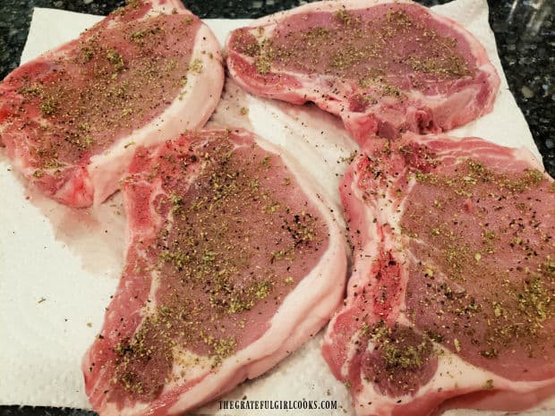 Pork chops are blotted dry, then lightly seasoned with salt, pepper and sage.