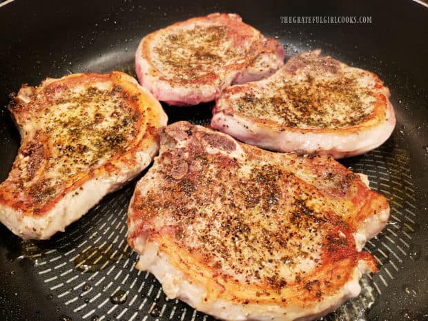 Both sides of the pork chops are pan-seared until browned.