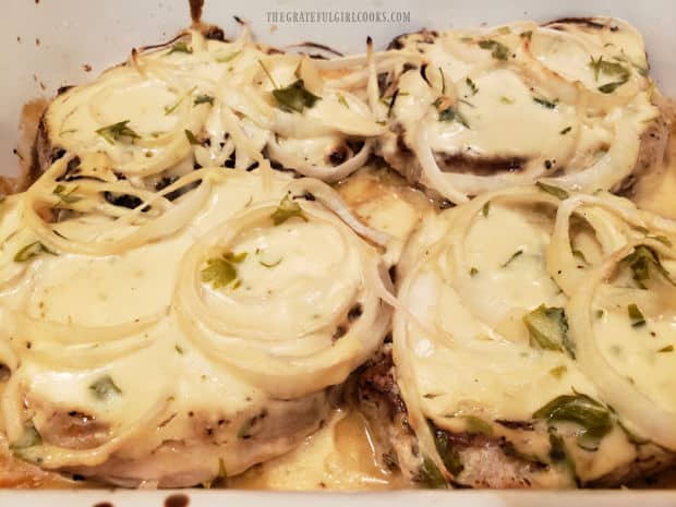 Pork Chops in Sour Cream Sauce are bubbly and browned, after baking.