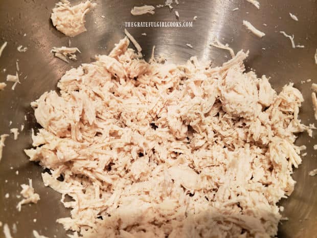 Chicken is shredded, then salsa, cheese, rice and seasonings are added.