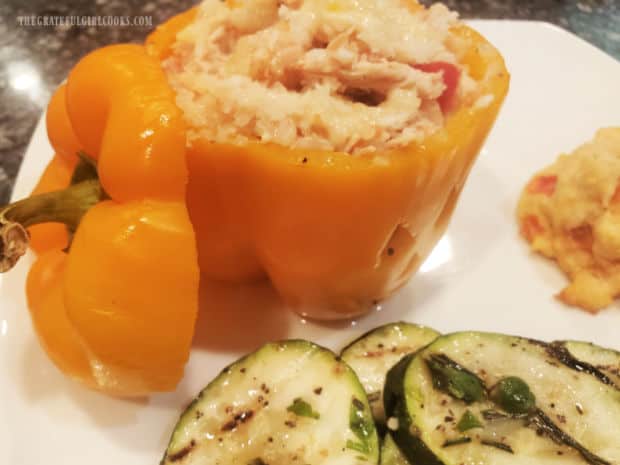 Zucchini is served with one of the stuffed jack o' lantern peppers.