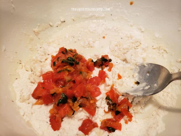 Tomato, onion and basil mixture is added to dry biscuit ingredients.