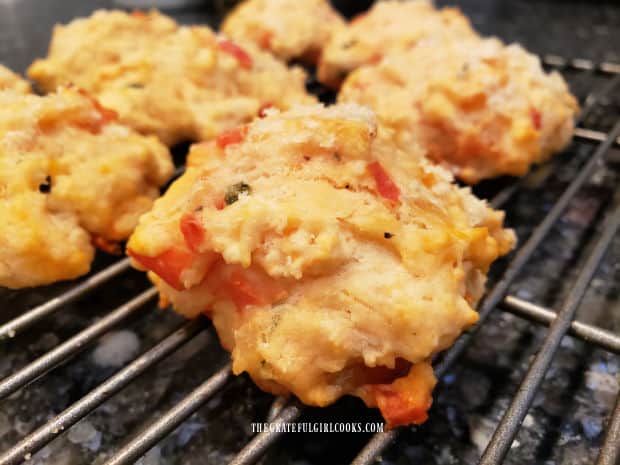Tomato basil drop biscuits continue cooling on a wire rack.