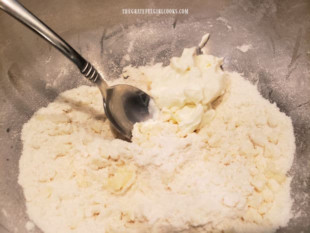 Sour cream is stirred into the cobbler topping until combined.