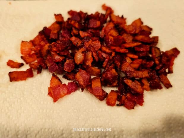 Bacon is cooked until browned and crispy, then drained on paper towels.
