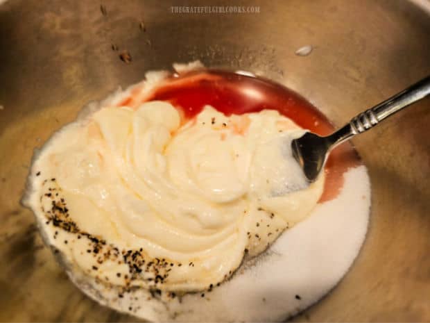 Salad dressing is made by stirring ingredients together in a small bowl.