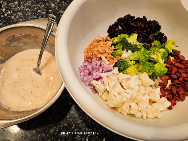Salad ingredients are placed in large bowl, and salad dressing is ready to add.