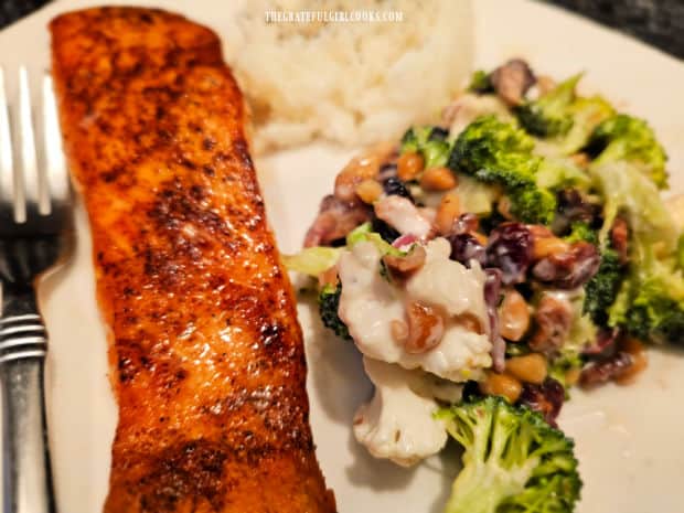 Salmon fillet and rice, served with the cauliflower broccoli bacon salad.