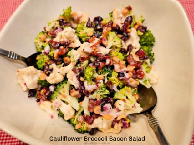 Enjoy the flavors of Cauliflower Broccoli Bacon Salad! Crisp veggies, bacon, dried cranberries, red onion and nuts, in a creamy vinaigrette.