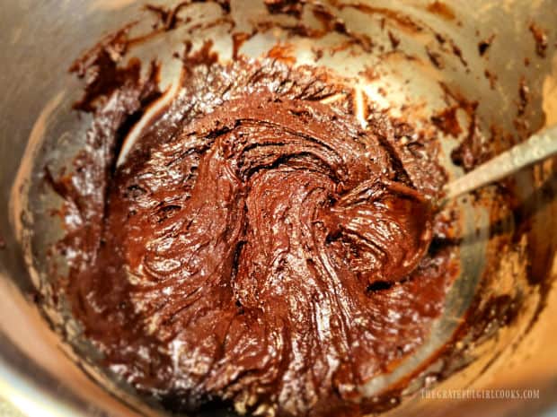 Wet and dry ingredients combine to make thick chocolate muffin batter.