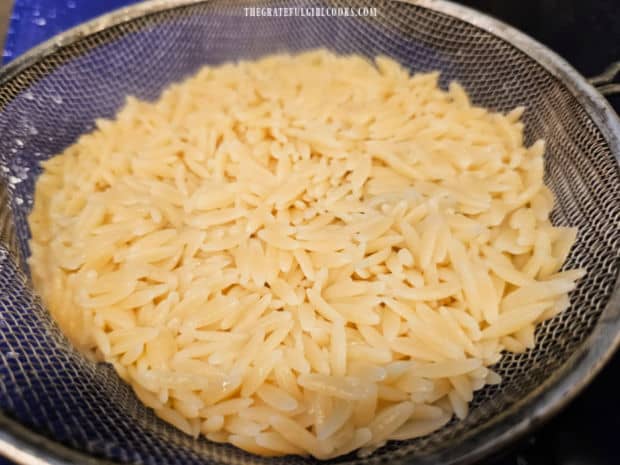 Cooked orzo is rinsed and drained well after it is finished cooking.