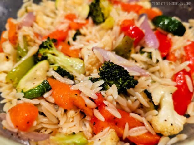 After being chilled, the roasted veggie orzo salad is ready to serve.