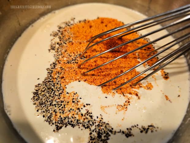 Egg filling for the quiche is whisked together in a bowl until combined.