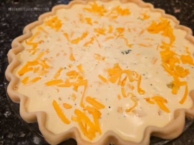 Egg filling for the quiche is poured over the veggie and cheese filling.