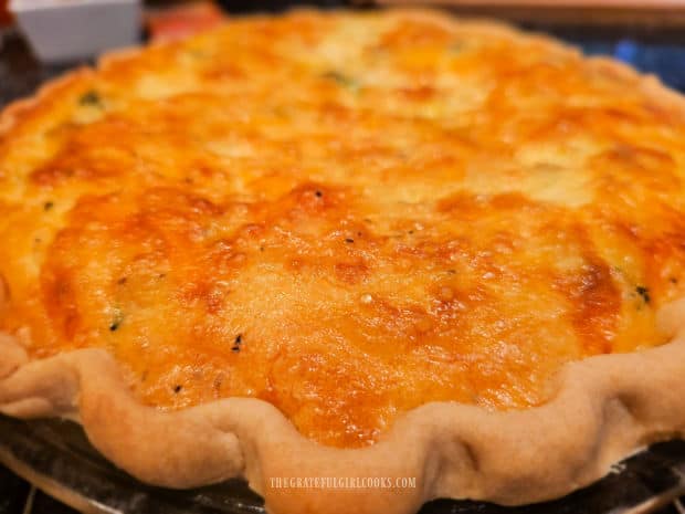 After baking, the Vegetable Cheddar Quiche is golden brown on top.