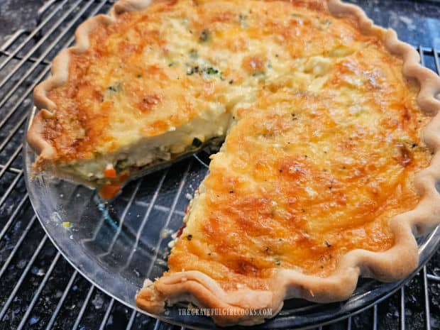 The vegetable cheddar quiche, with one slice already removed.