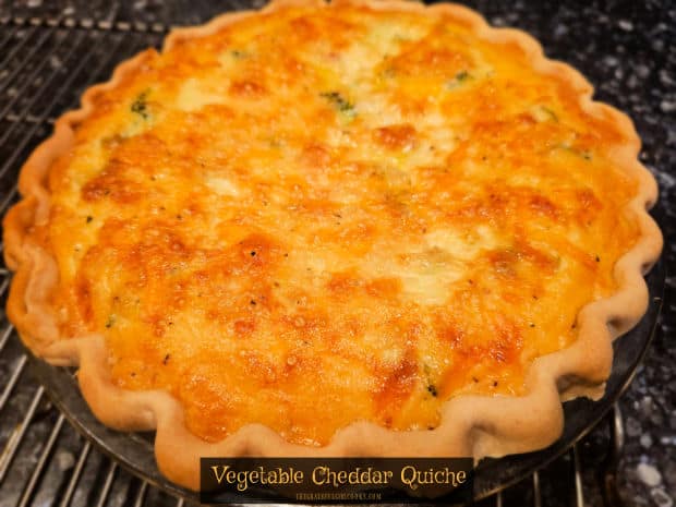 Make a delicious vegetable cheddar quiche to enjoy at breakfast, lunch or dinner! Easy to make, and filled with cheese and lots of veggies. 