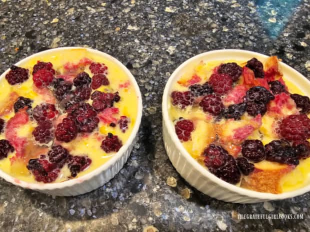 Egg mixture is poured over bread cubes and blackberries before refrigerating.