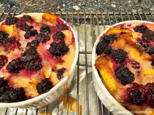 Tow baked Blackberry French Toast Cups cooling on a wire rack.
