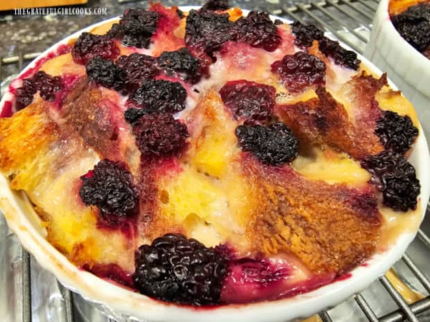 A close up of one of the French toast cups cooling on a rack after baking.