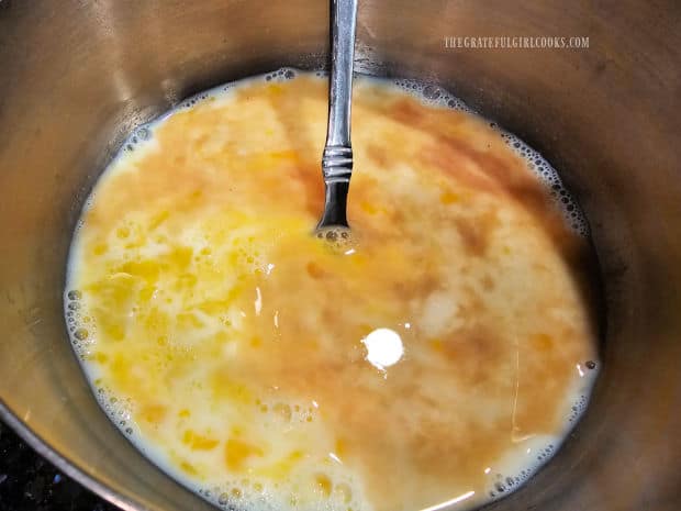 Milk, egg, and vanilla extract are mixed together in a bowl.