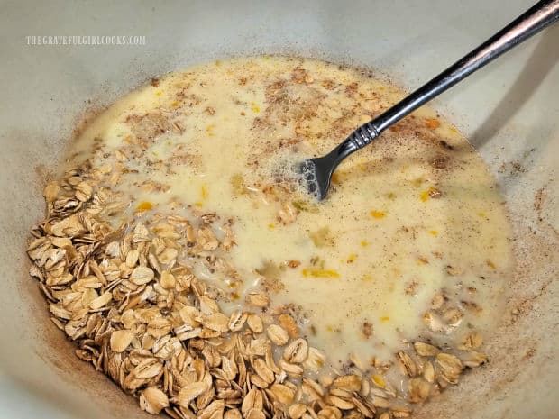 Egg and milk mixture is added to oat mixture and stirred, to combine.