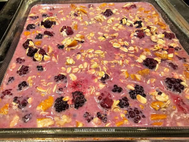 Batter for baked oatmeal is poured into a greased 8"x8" baking dish.