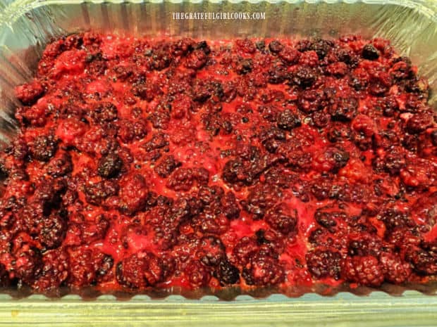 A baking dish filled with the blackberry fruit filling.