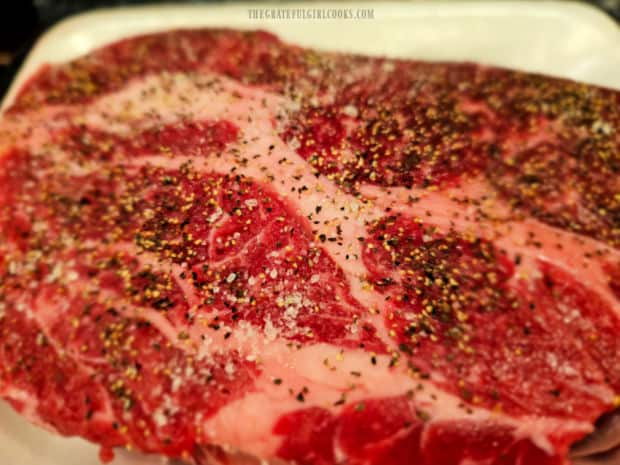 Chuck roast is seasoned on all sides with salt and pepper.