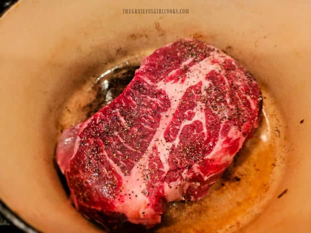 Roast is pan-seared in hot oil in a Dutch oven.