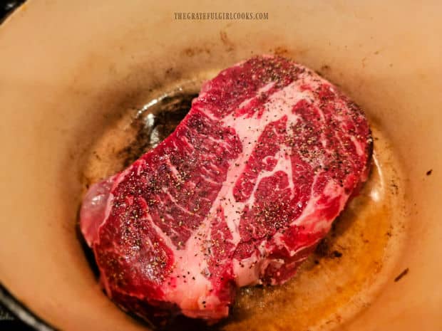 Roast is pan-seared in hot oil in a Dutch oven.