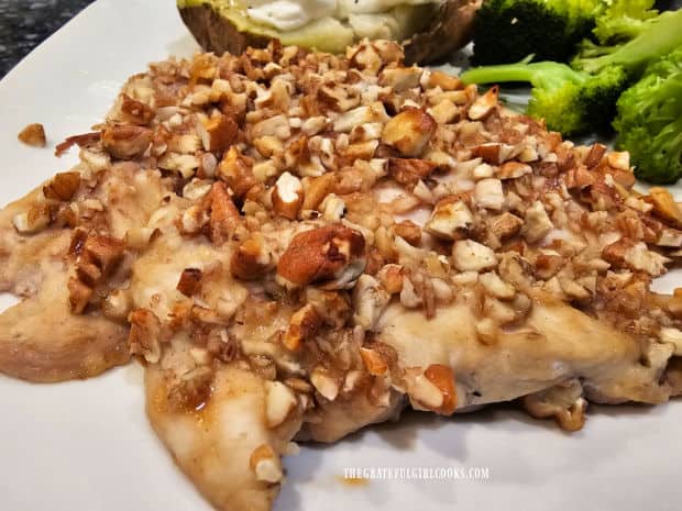 A close up photo of the pecan-crusted chicken on a white plate.