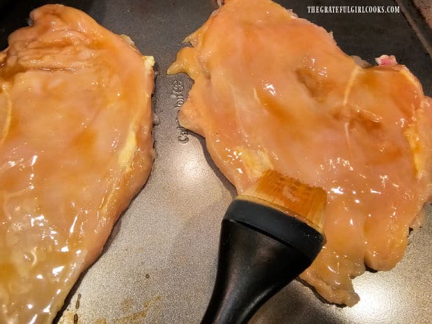 Honey Dijon glaze is brushed over the chicken breasts.