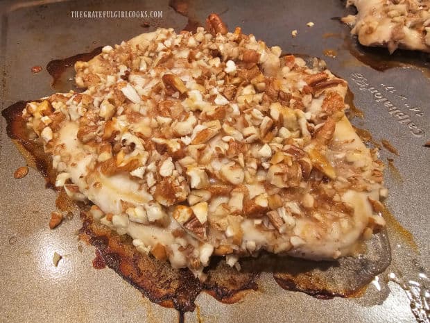 Pecan-crusted chicken rests on baking sheet after cooking.