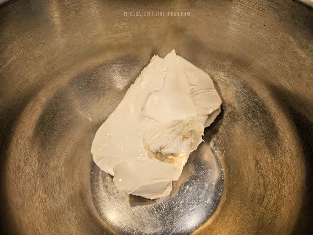 Eight ounces of softened cream cheese is placed in a mixing bowl.