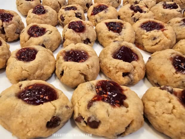 A white platter is used to serve the raspberry thumbprint cookies.