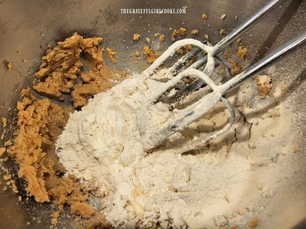 Sifted flour and milk are mixed into the cookie dough.