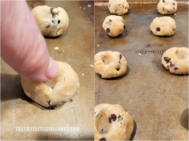 A thumb is used to slightly indent cookie dough balls on a baking sheet.