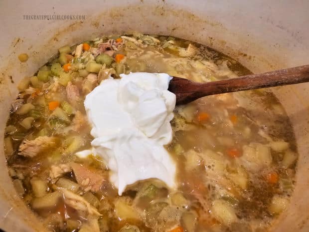 Once rice is tender, sour cream is stirred into the soup and simmered.