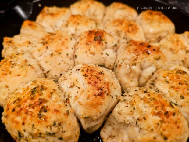 After baking, the garlic butter herb rolls are golden brown on top.