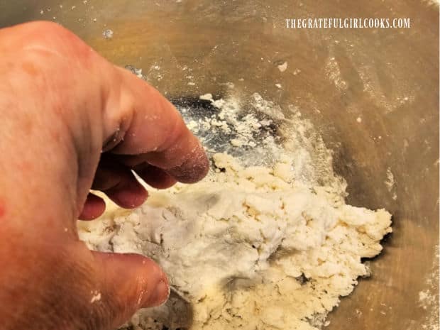 Crumbly peppermint dough is kneaded by hand until it is compacted.