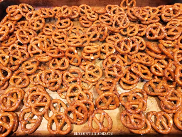 Seasoned pretzels on baking sheet in one layer, ready for oven.